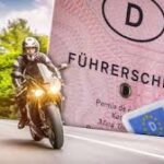 Ein Autofahrer schaut sich interessiert ein 125ccm Leichtkraftrad an, passend zur Option eine B196 Bescheinigung kaufen zu können.